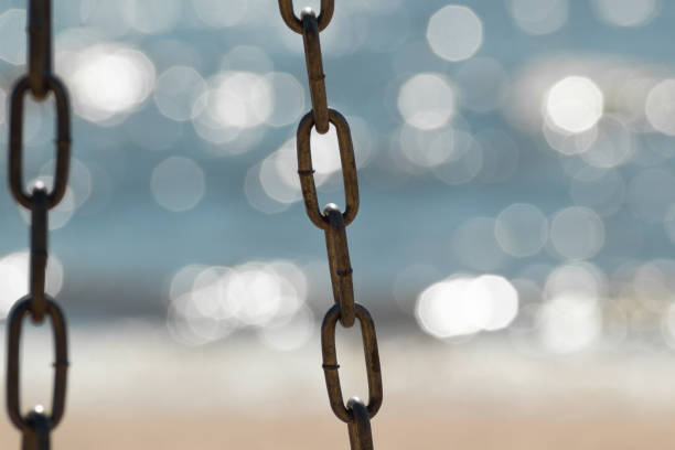 istock Metal chain isolated on sparkle water 1298990392