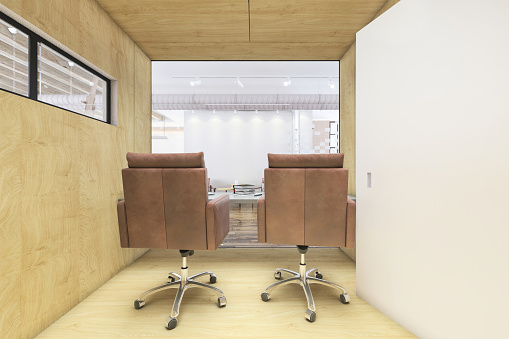 Contemporary open plan office interior with office cubicle. Blank screen laptops, office desk, Template for copy space. Render.