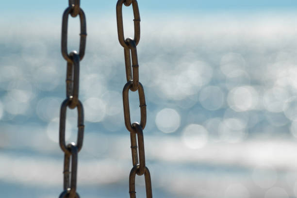 istock Metal chain isolated on sparkle water 1298990458