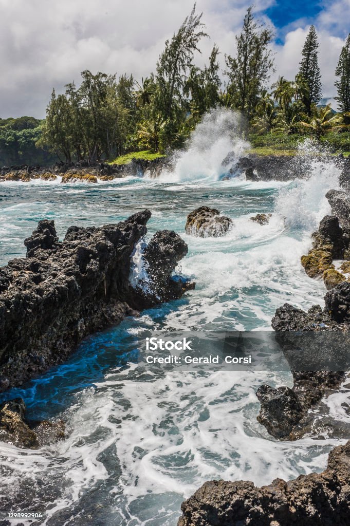 Pacific Ocean waves breaking on a rocky beach by the Hana Road in Maui, Hawaiian Islands Beach Stock Photo