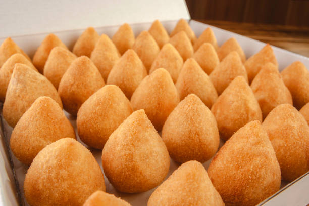 Brazilian snacks A box of deep fried croquettes for delivery (coxinha de frango) - Close-up coxinha stock pictures, royalty-free photos & images