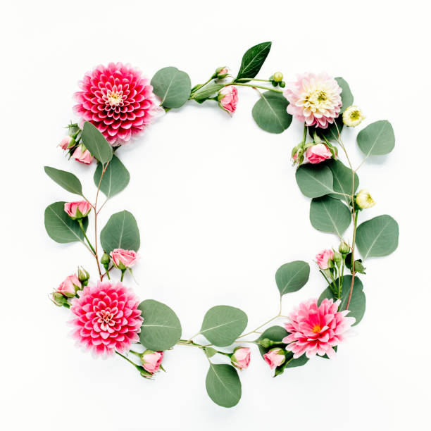 istock Round frame with pink flower buds, branches and leaves isolated on white background. lay flat, top view 1298994498