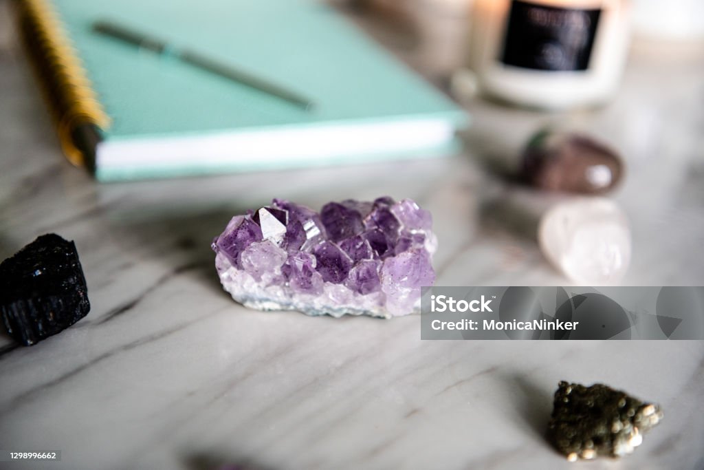 Flat lay of healing crystals and notebook Amethyst Stock Photo