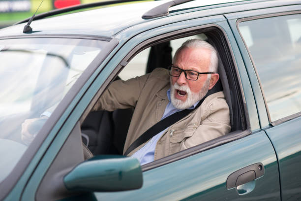 istock Senior man in car road rage in traffic 1298996730