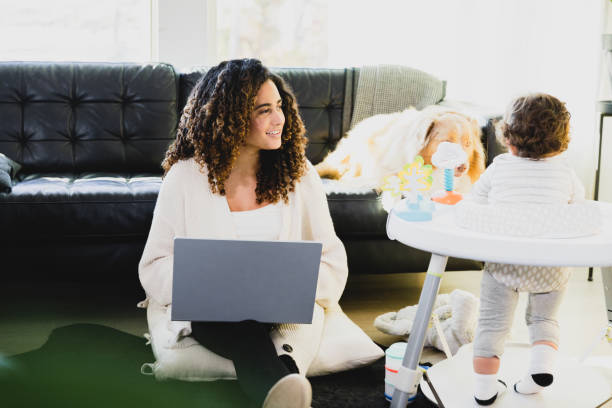 istock Mom telecommutes while son plays in activity chair 1298997033