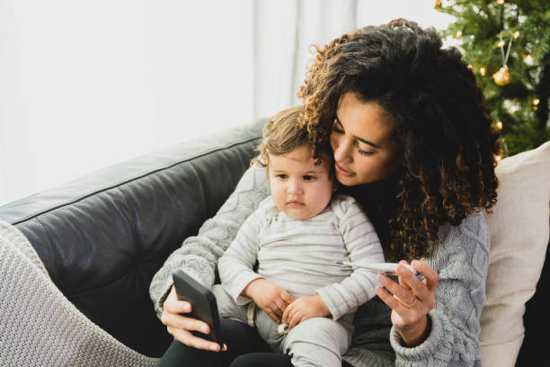 Worried mom talks with son's doctor during telemedicine visit A worried young adult mother discusses her toddler son's high fever with a pediatrician during a telemedicine appointment. virtual event stock pictures, royalty-free photos & images