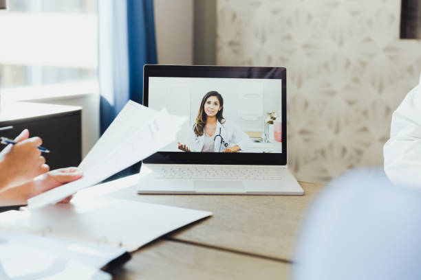 istock Female doctor talks with colleagues during virtual meeting 1298997723