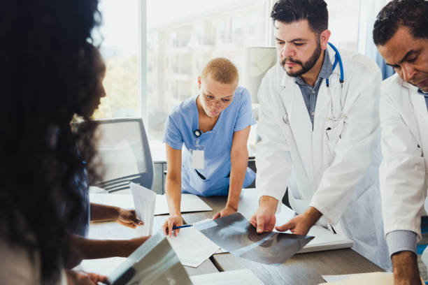 istock Doctors review patient's x-ray during meeting 1298997725