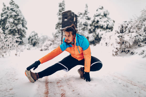 istock Young men warming up in snowy forest 1298998176