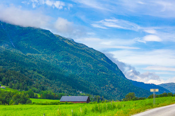 istock Incredible norwegian landscape with mountains clouds forests Jotunheimen Norway. 1298998987
