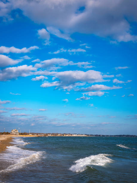 istock Dramatic cloudscape over the rocky beach with splashing waves 1298999542