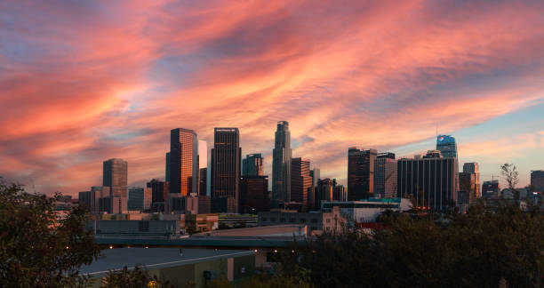 DTLA at sunset with a pink color sky Los Angeles city skyline illuminated at night los angeles county stock pictures, royalty-free photos & images