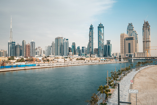 Dubai, UAE - September 30, 2022:  Swimming pool on the Palm Jumeirah with people relaxing and sunbathing by the water