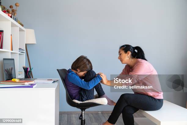 Mother Talking To Bored Schoolboy Having Elearning Stock Photo - Download Image Now