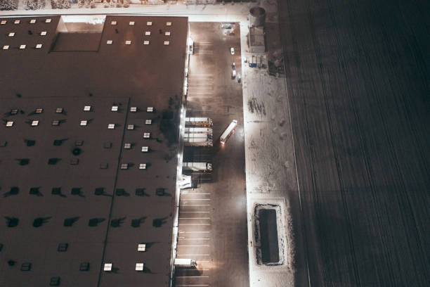istock Aerial view of the trucks unloading at the logistic center. 1299005780