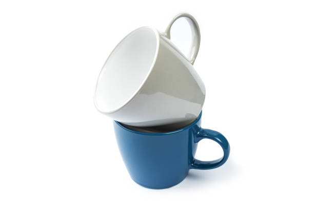 istock blank ceramic colored cup isolated over white background. stack of teacup cut out 1299008388