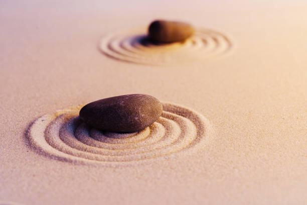 istock Zen garden stones on sand with ornament 1299011868