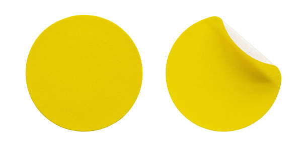 istock Yellow round paper sticker label isolated on white background 1299012043