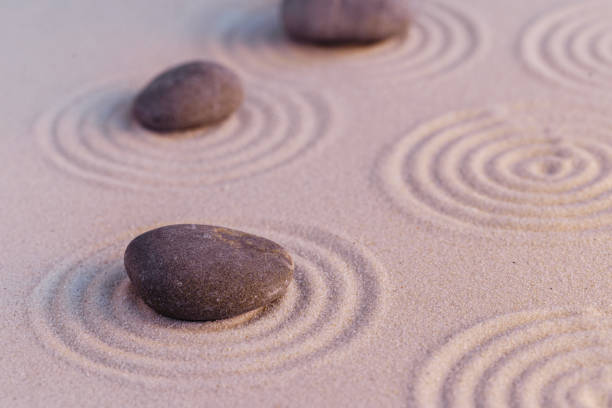 istock Zen garden stones on sand with ornament 1299013420