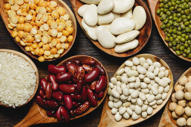 istock dried beans in wooden spoons on the table 1299013619