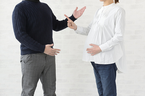 Quarrel between pregnant wife and husband in living room