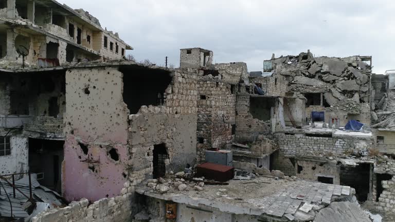 Drone flying over ruins of buildings in Aleppo, Syria. We can see destroyed buildings in the street of the city 4K