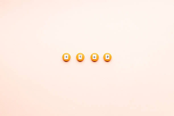 istock orange drugs with stop sign isolated over pink background. above view. outer space. stop medication concept 1299025635