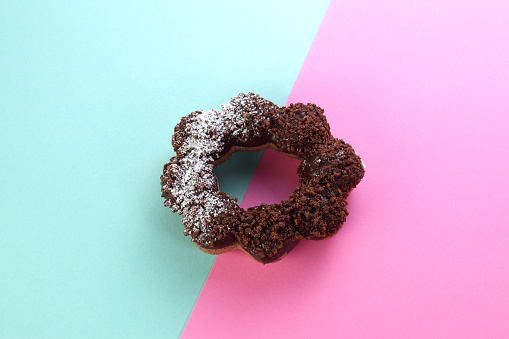 Sweet donut on blue and pink background