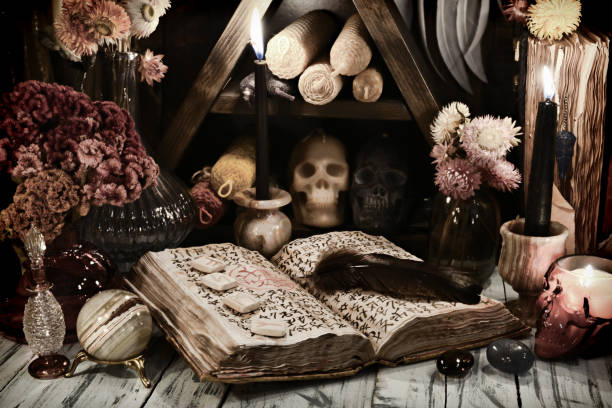Still life with old grimoire book of magic spells, runes and evil candles on witch table. Still life with old grimoire book of magic spells, runes and evil candles on witch table. Esoteric, gothic and occult background, No foreign symbols, all signs are fantasy one. runes photos stock pictures, royalty-free photos & images