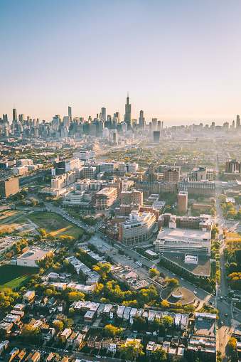 Aerial view of Chicago, Illinois seen from a helicopter during sunrise golden hour.