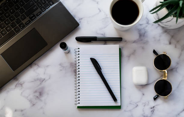 istock Top view of office desk flat layout productivity concept 1299035713
