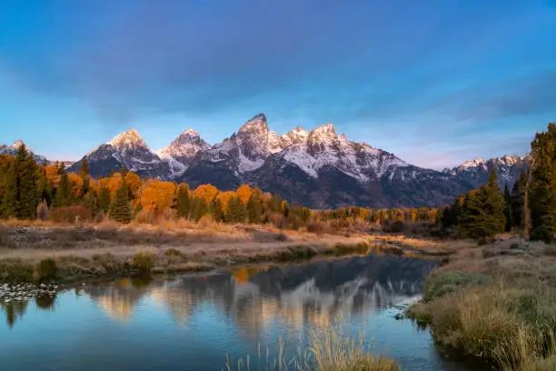 morning shot of grand teton after an autumn snowstorm from schwabacher landing in grand teton national park of wyoming, usa