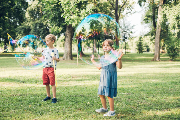 istock Cute Kids Playing In Green Park 1299036421