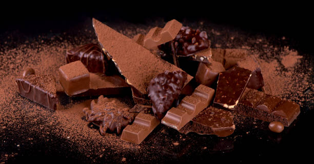 istock dark chocolate over wooden background, selective focus 1299038676
