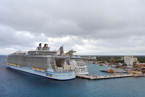 San Miguel de Cozumel, Mexico -- January 25, 2019:Looking at cruise ships docked in Cozumel, Mexico as storm clouds approach. Cozumel is a common stop for cruise ships in the Caribbean Sea.