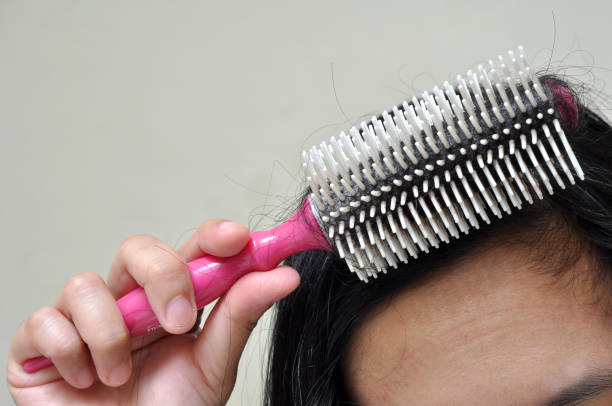 istock The woman is combing her long hair 1299040727