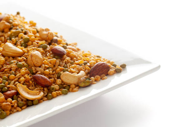 istock 'Shahi Mixture' in a white ceramic square plate, made with peanut, cashew, corn flakes, almonds 1299046125