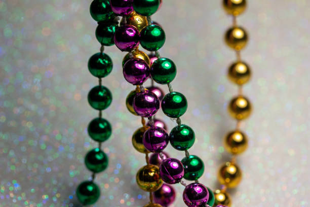 istock Macro abstract texture background of Mardi Gras beads on a white glitter background 1299046774