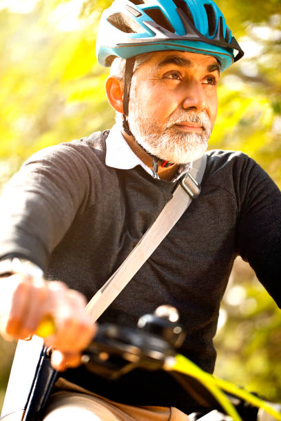 istock Mature man enjoying a bicycle ride 1299047023
