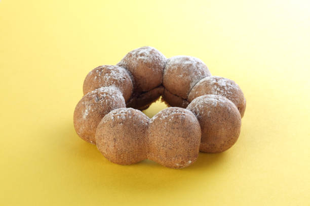 istock Fresh sweet donut on yellow background 1299048345