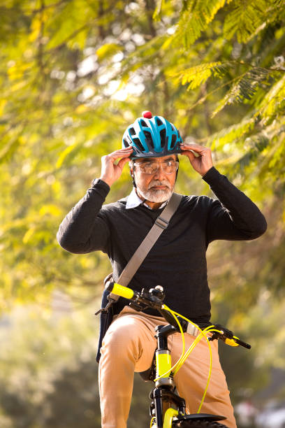 istock Man wearing bicycle helmet before ride 1299048497