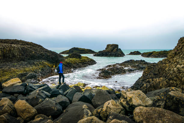 istock Standing man on the rocks 1299049428