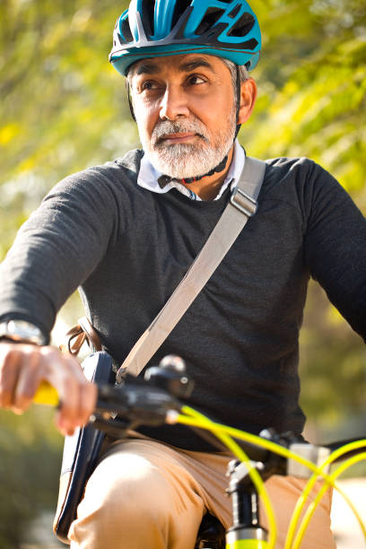 istock Mature man enjoying a bicycle ride 1299049571