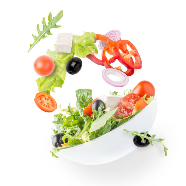 Vegetarian salad. A light spring salad of fresh vegetables. arugula falling stock pictures, royalty-free photos & images