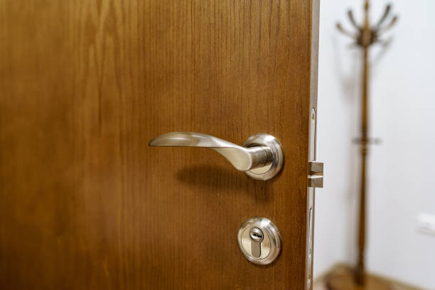 istock Wooden door with metal door handle and lock 1299050507