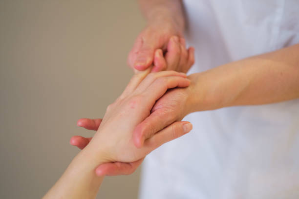 istock Wrist massage. massage therapist puts pressure on a sensitive point on a woman's hand. Physiotherapist massaging her patients hand in medical office 1299052567