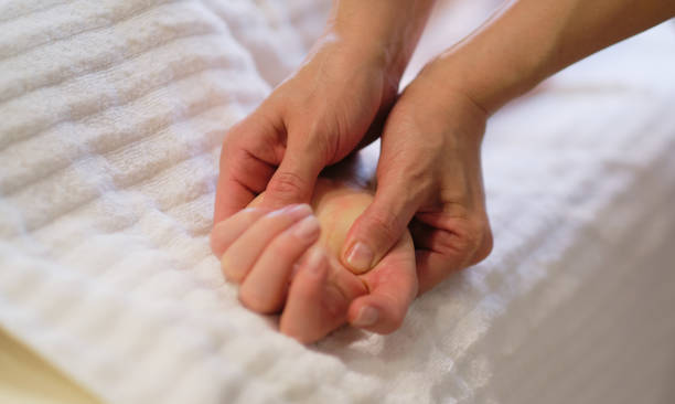 istock Wrist massage. massage therapist puts pressure on a sensitive point on a woman's hand. Physiotherapist massaging her patients hand in medical office 1299052578