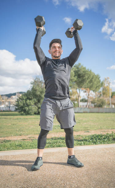 istock athletic man doing squat and back exercise and cross training with dumbbells 1299052712