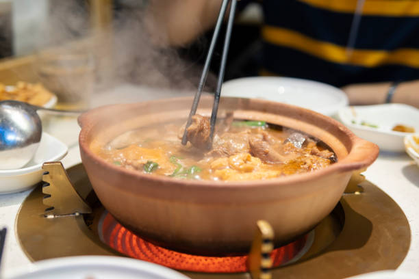 istock Chopsticks picking up a piece of Beef Brisket from hot pot 1299054051