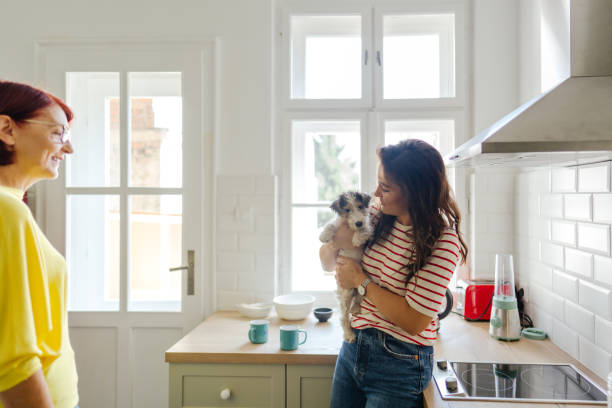 istock Mother and daughter having a cup of coffee together 1299057969